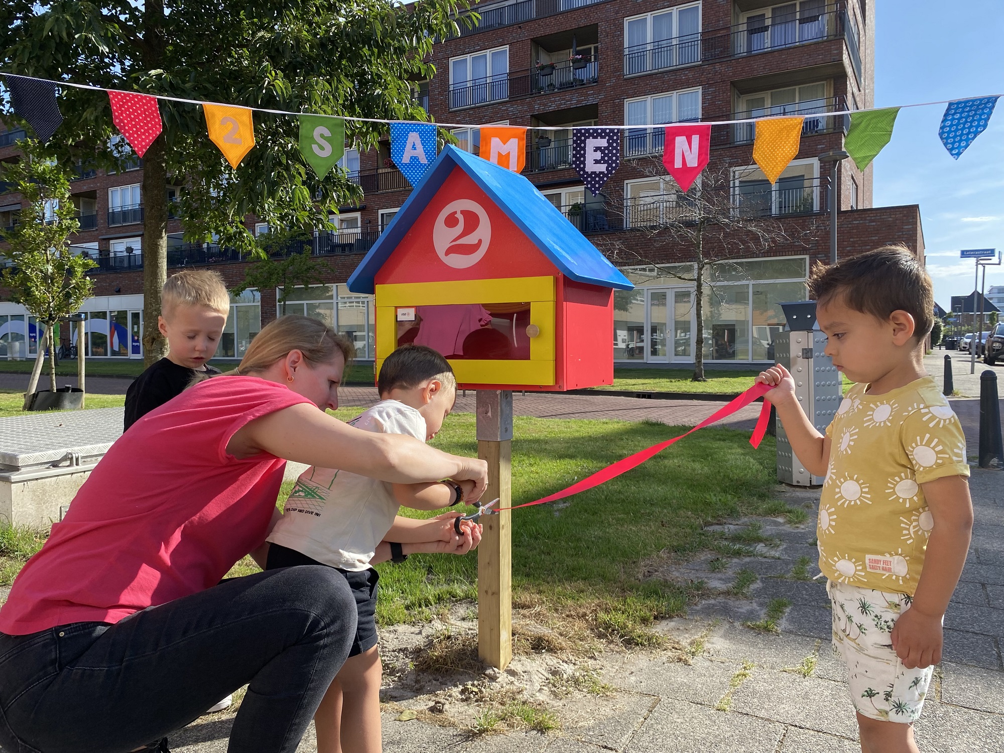 Finn, Jens, Frenkie (3 jaar) openen hun mini-bieb met samen pm'er Esther bij kinderdagverblijf 2Eekhoorns in de wijk Hoogeland in Naaldwijk